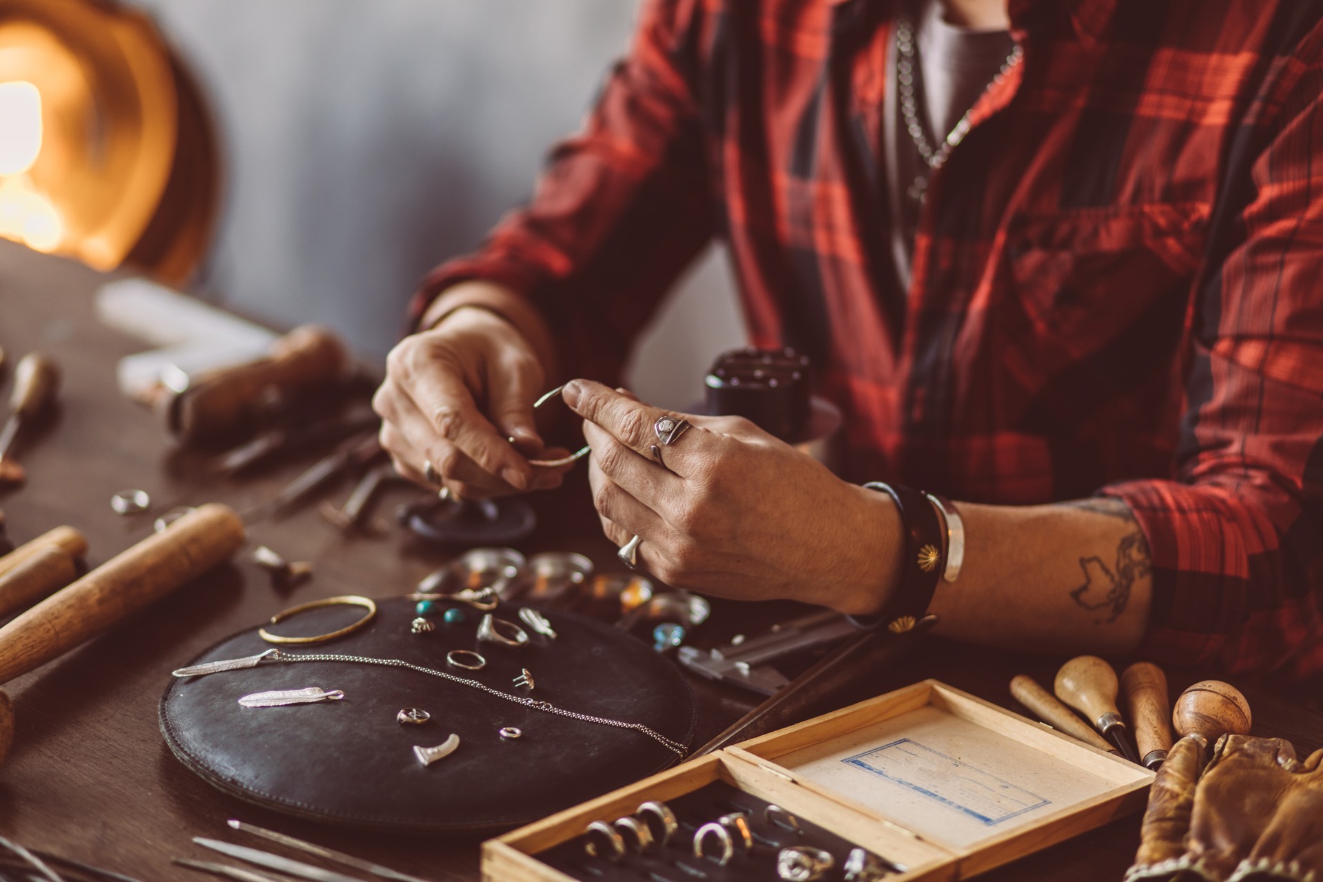 Jeweler working with chain in the workshop