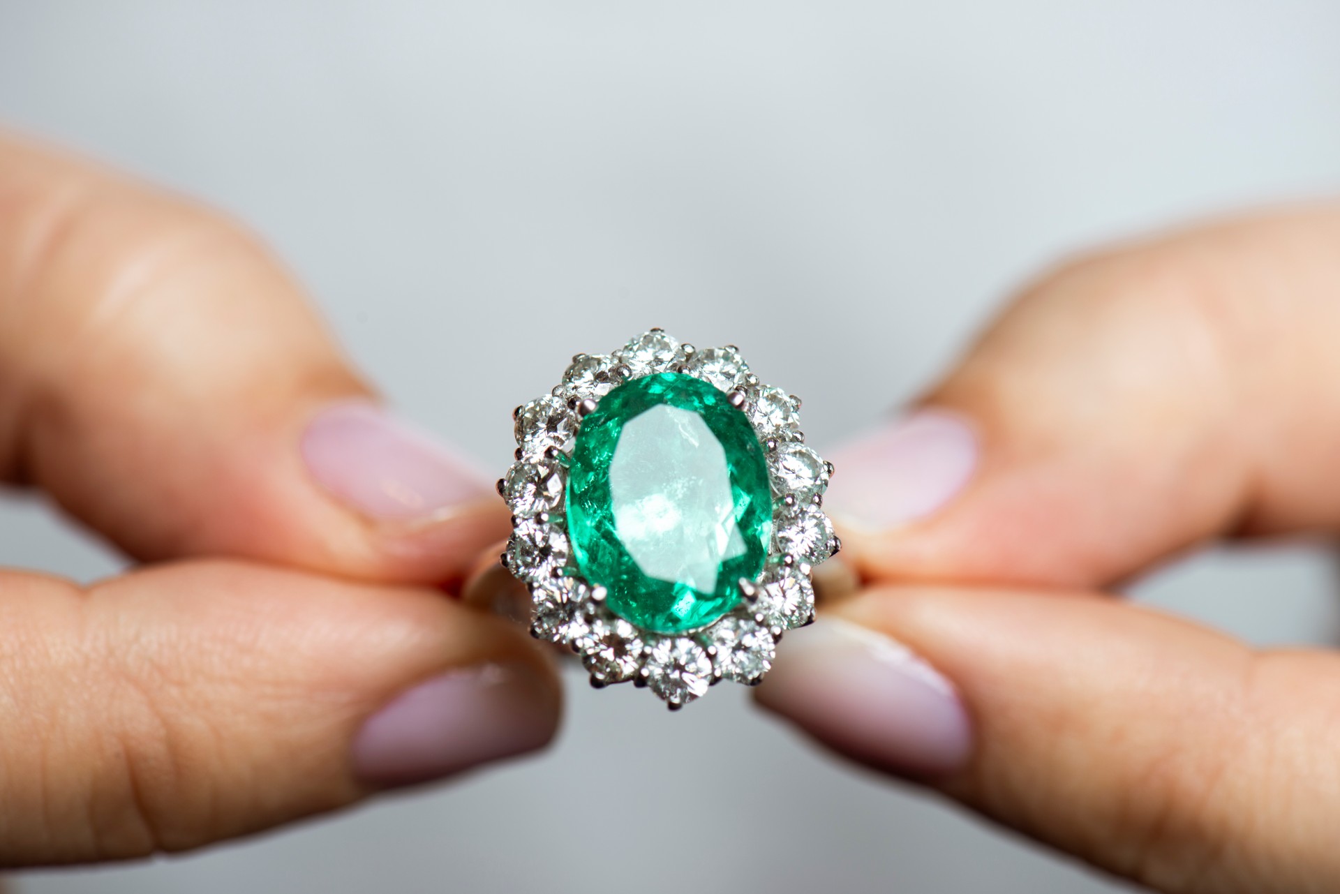 Woman Holding A Green Diamond Ring